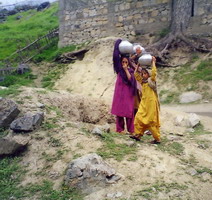 Little girls carrying water down from a spring in the foothills of the Hindukush.