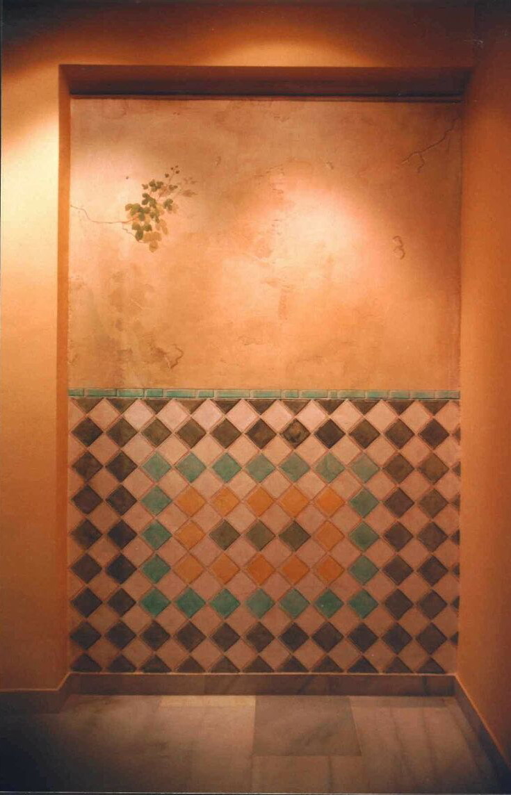 Mural: At the end of a corridor, a wall painted to look like an old plaster wall with Al-Andalus tiles.